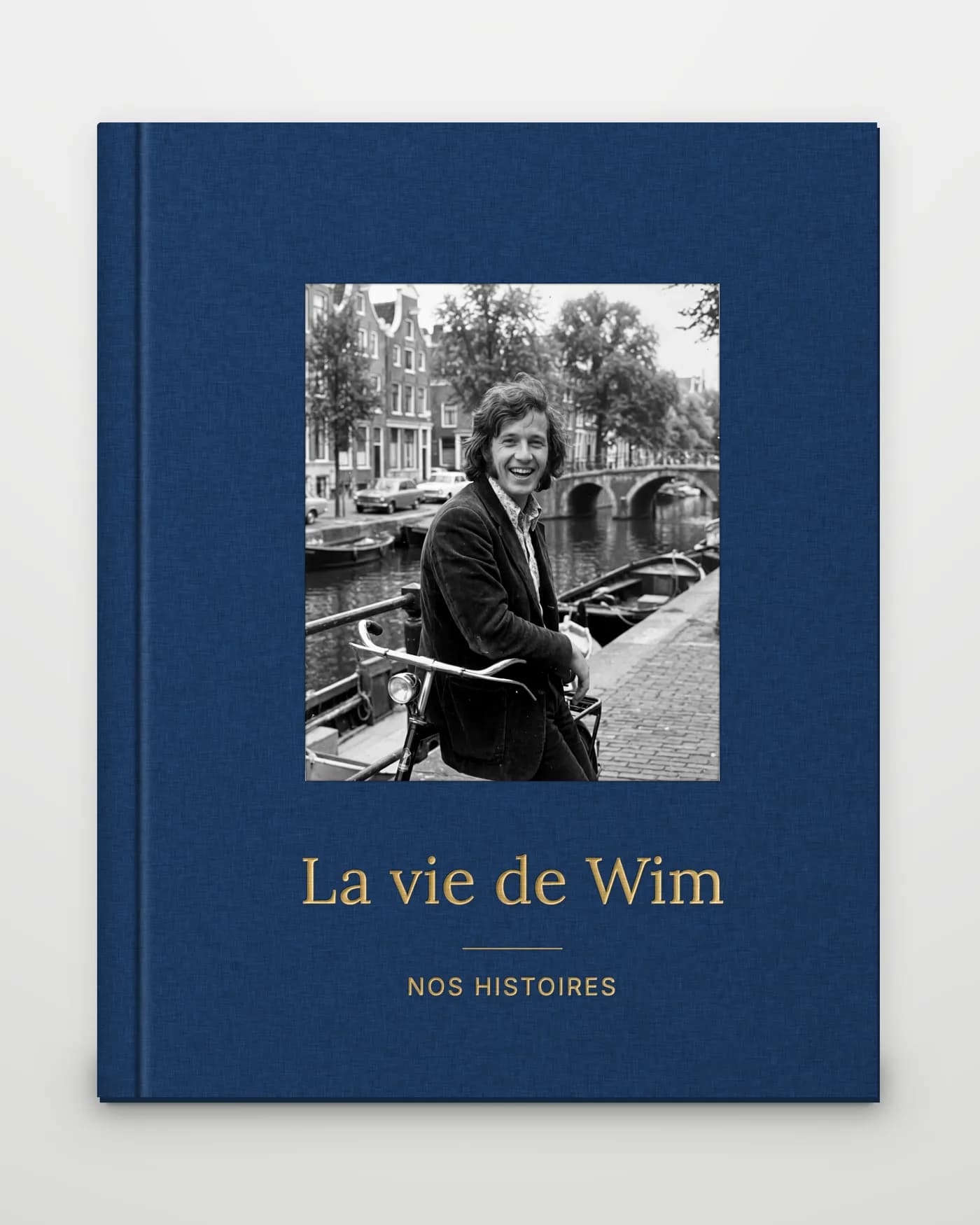 Une carte cadeau Nos Histoires sur une enveloppe, avec une lettre pliée et un ruban à côté, sur une table en chêne.